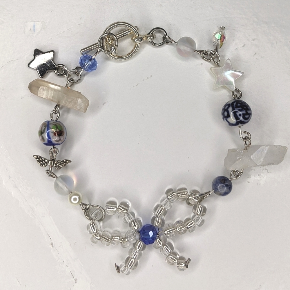 Bracelet with wire beaded bow and blue colored beads. Handmade by me.